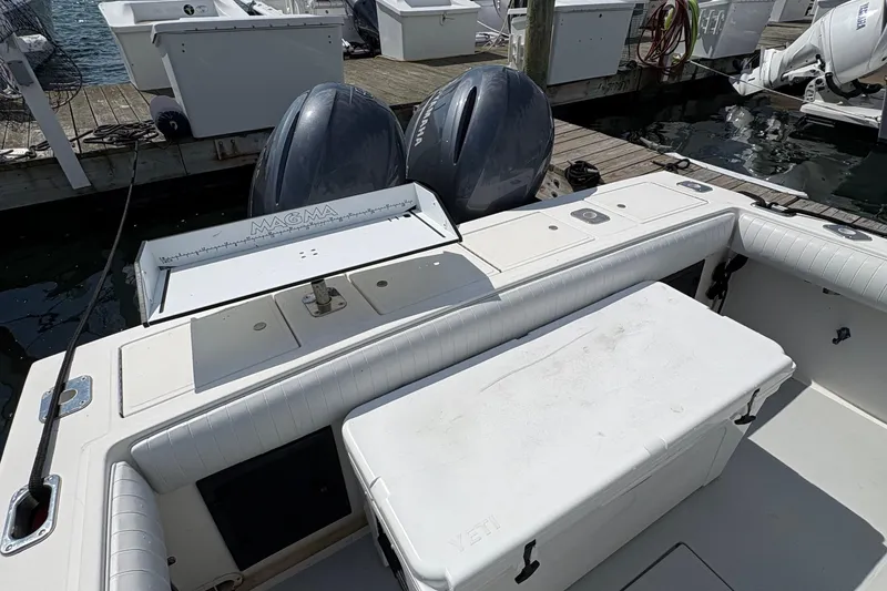 Slide: The Image of 2000 Regulator 26 Center Console boat with dual engines and fishing setup. - 6