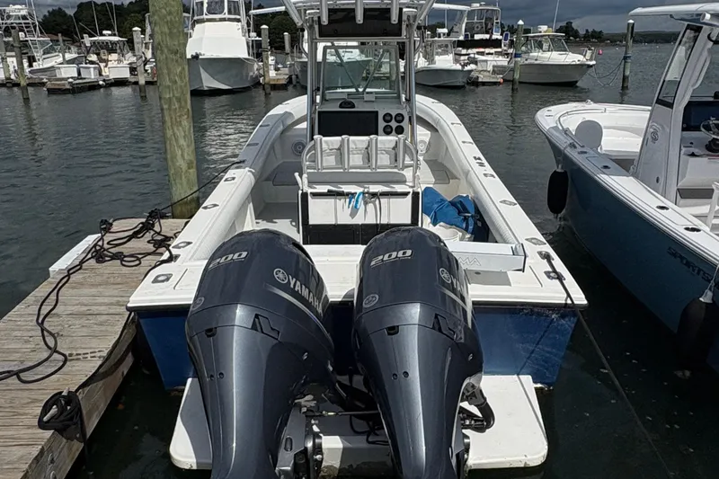 Slide: The Image of 2000 Regulator 26 Center Console boat with twin Yamaha 200 engines docked at marina. - 7