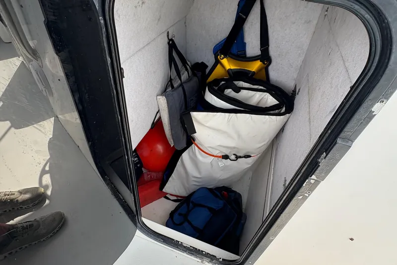 Slide: The Image of Storage compartment on a 2000 Regulator 26 Center Console boat with various gear. - 8