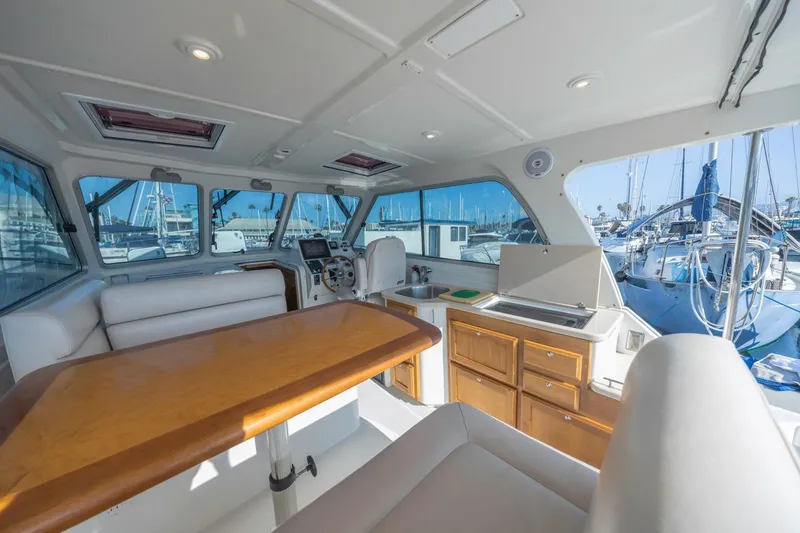 Slide: The Image of Interior of 2008 Back Cove 33 yacht with seating, table, and kitchenette. - 10