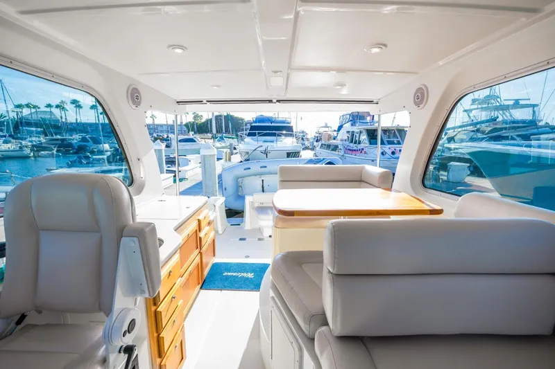 Slide: The Image of Interior of 2008 Back Cove 33 yacht with luxurious seating and marina view. - 13