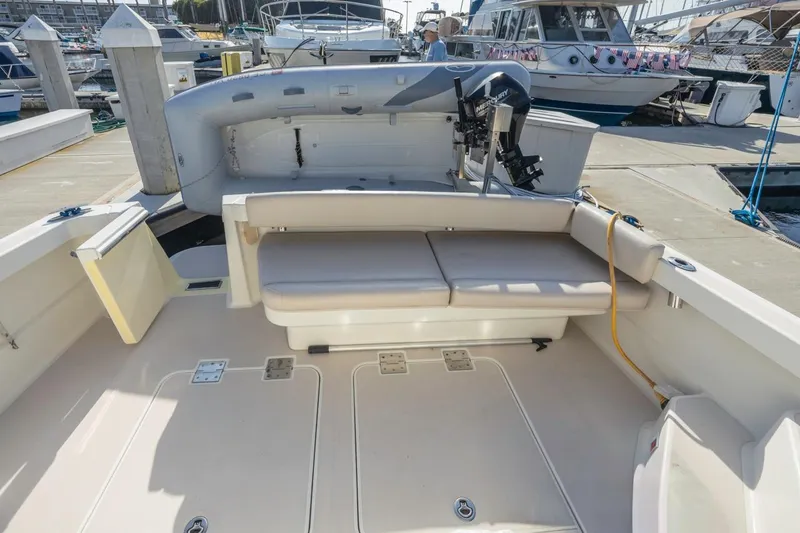 Slide: The Image of 2008 Back Cove 33 boat interior with seating and docked at marina. - 14