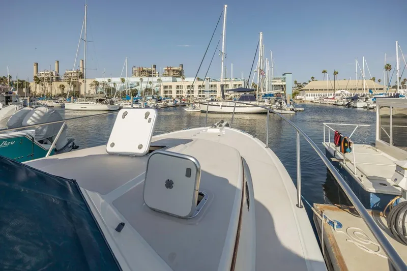 Slide: The Image of 2008 Back Cove 33 yacht docked in a marina with sailboats and buildings. - 15