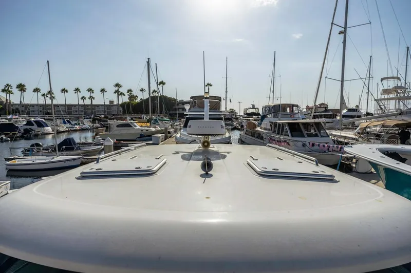 Slide: The Image of 2008 Back Cove 33 yacht docked in a marina with surrounding boats. - 17