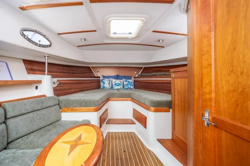 Slide: The Image of 2008 Back Cove 33 interior with cozy cabin, wood accents, and nautical decor. - 18