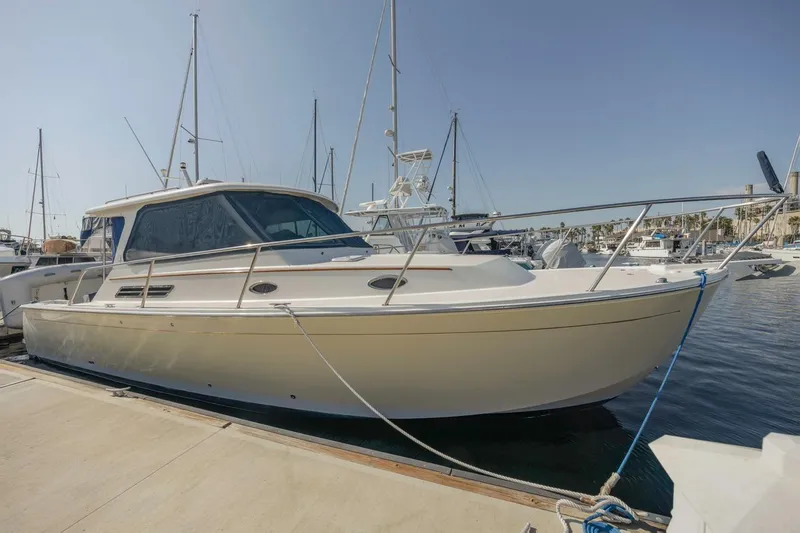 Slide: The Image of 2008 Back Cove 33 yacht docked at marina under clear sky. - 2