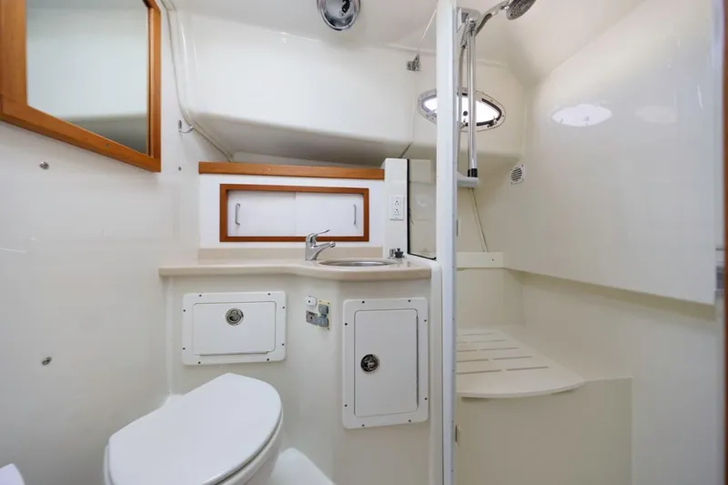 Slide: The Image of 2008 Back Cove 33 yacht bathroom with shower, sink, and toilet in compact, modern design. - 20