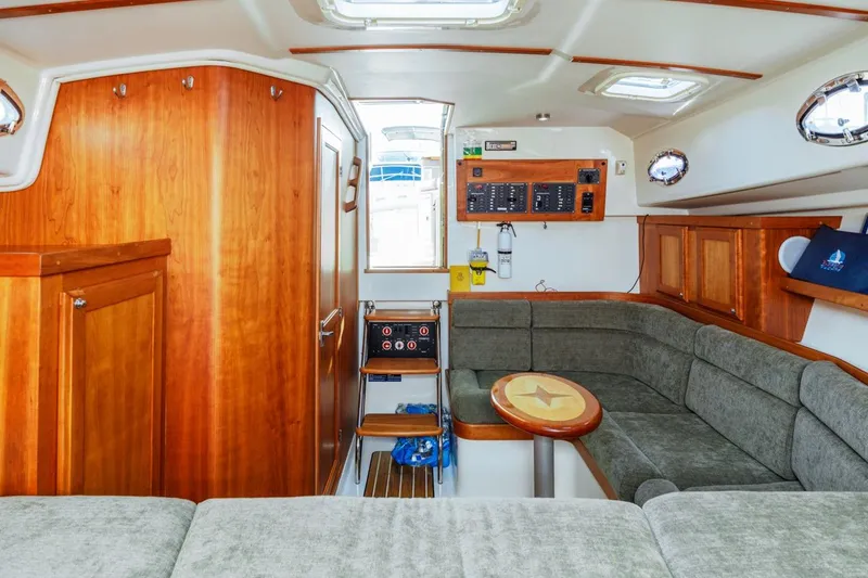 Slide: The Image of 2008 Back Cove 33 yacht interior with wood paneling and plush seating. - 21