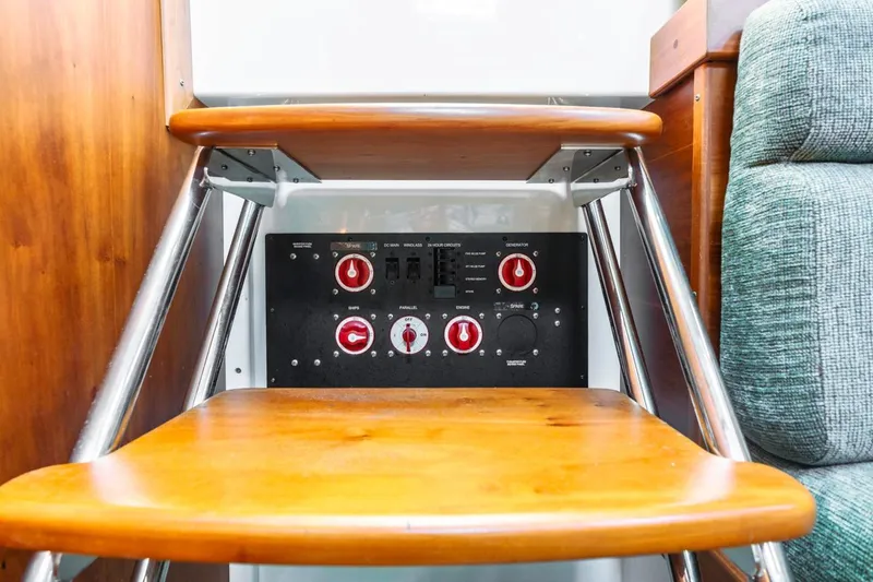 Slide: The Image of 2008 Back Cove 33 yacht interior with wooden steps and control panel. - 24