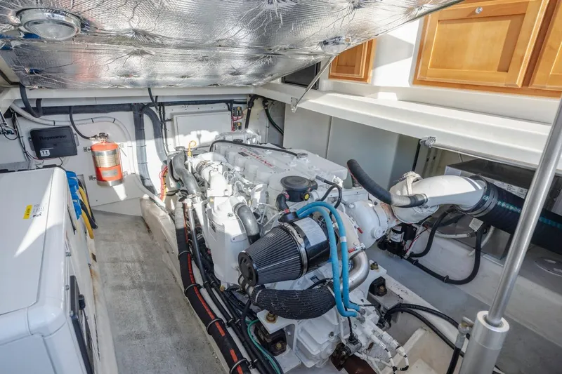 Slide: The Image of Engine room of a 2008 Back Cove 33 boat, showcasing a well-maintained engine and equipment. - 26