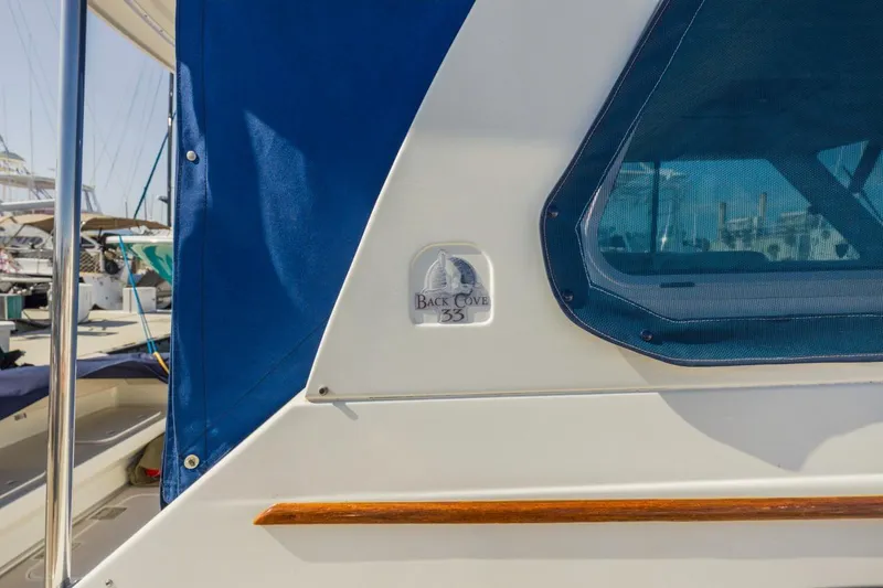 Slide: The Image of 2008 Back Cove 33 boat with blue canopy and window detail. - 6