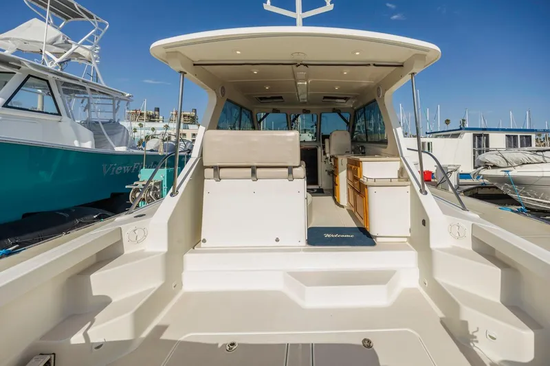 Slide: The Image of 2008 Back Cove 33 yacht interior, featuring spacious seating and modern amenities at the marina. - 7