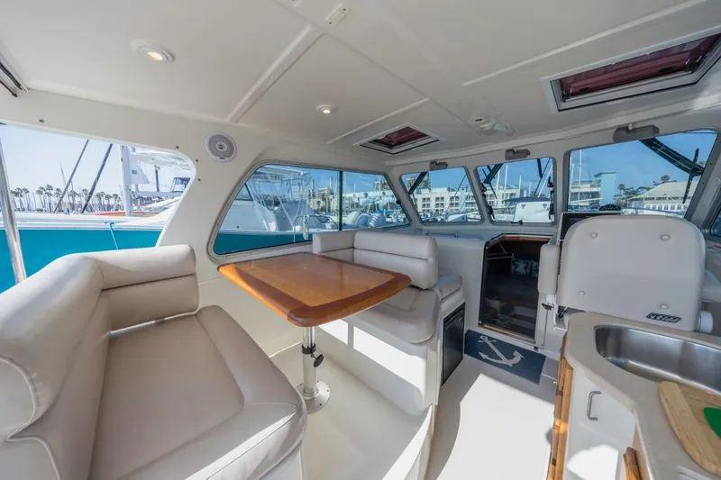 Slide: The Image of Interior of 2008 Back Cove 33 yacht with seating and table, docked at marina. - 9