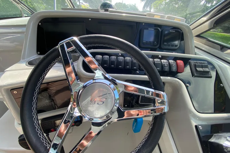 Slide: The Image of Steering wheel and dashboard of a 2005 Formula 280 Sun Sport boat. - 32