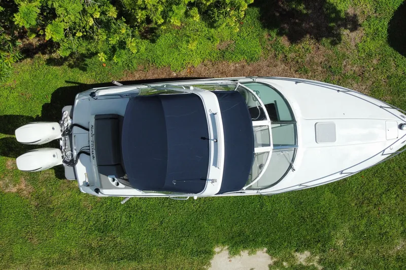 Slide: The Image of Aerial view of 2005 Formula 280 Sun Sport boat on grass, surrounded by greenery. - 52