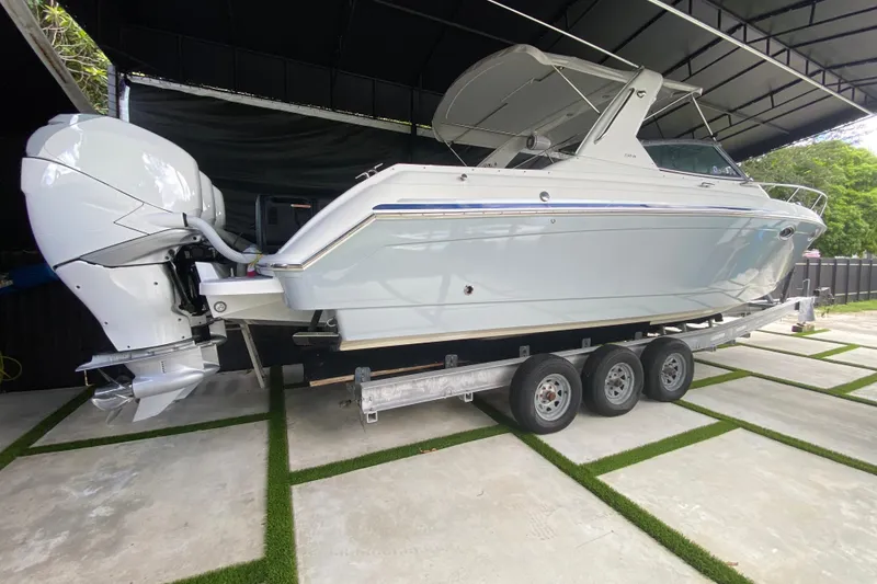 Slide: The Image of 2005 Formula 330 Sun Sport boat on trailer under shelter. - 11