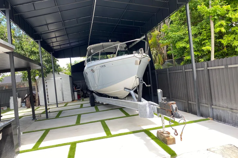 Slide: The Image of 2005 Formula 330 Sun Sport boat on trailer under a covered storage area. - 12