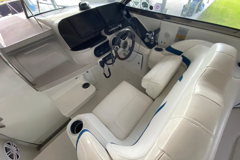 Slide: The Image of 2005 Formula 330 Sun Sport boat interior with white seating and modern dashboard. - 21