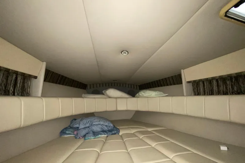 Slide: The Image of Interior cabin of 2005 Formula 330 Sun Sport boat with beige upholstery and bedding. - 29