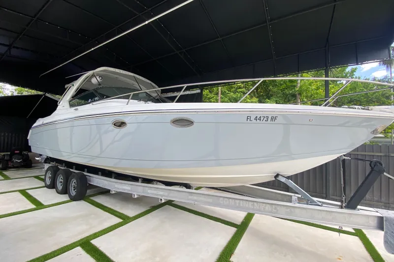 Slide: The Image of 2005 Formula 330 Sun Sport boat on trailer in covered storage area. - 3