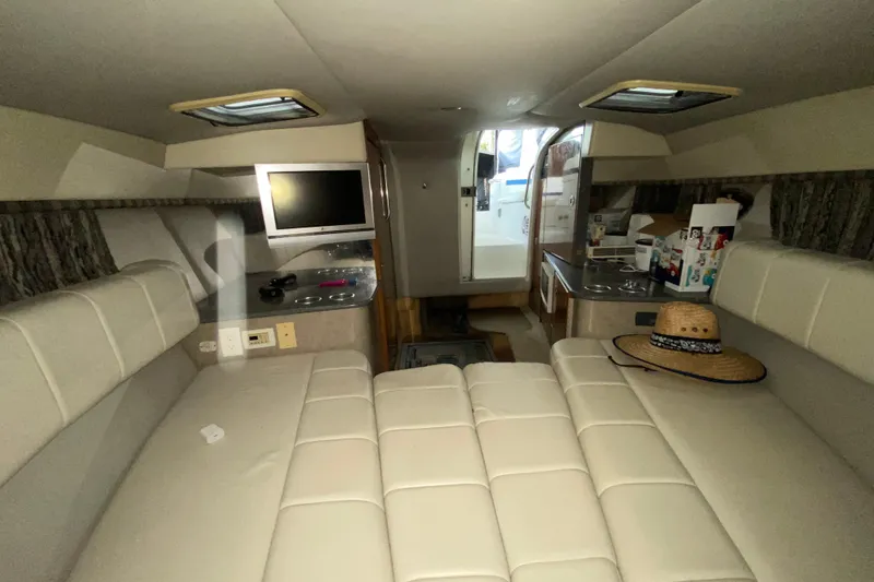 Slide: The Image of Interior of 2005 Formula 330 Sun Sport boat with seating, TV, and kitchenette. - 30