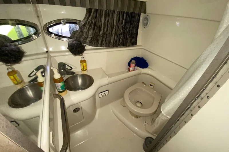 Slide: The Image of Compact bathroom in 2005 Formula 330 Sun Sport boat with sink and toilet. - 31