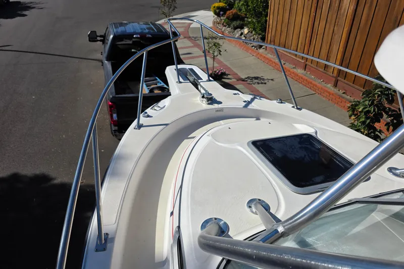 Slide: The Image of 2003 Boston Whaler 255 Conquest boat on trailer, parked on street. - 14