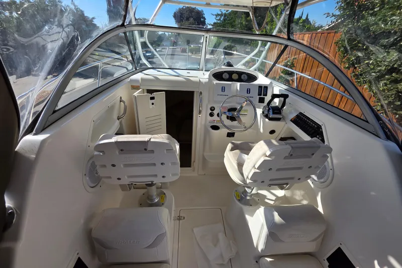 Slide: The Image of 2003 Boston Whaler 255 Conquest boat interior with steering wheel and seating. - 16