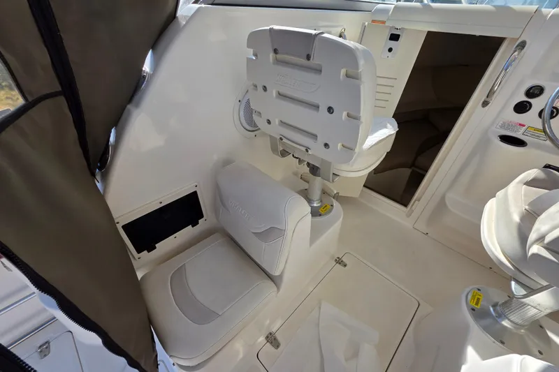 Slide: The Image of Interior of 2003 Boston Whaler 255 Conquest boat, featuring seating and helm area. - 19
