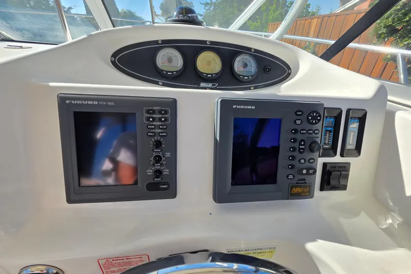 Slide: The Image of 2003 Boston Whaler 255 Conquest dashboard with Furuno navigation systems and gauges. - 21