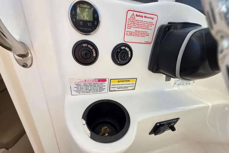 Slide: The Image of Control panel of a 2003 Boston Whaler 255 Conquest boat with safety warnings. - 24