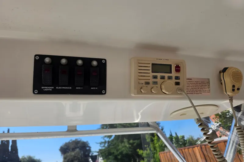 Slide: The Image of Control panel and radio on a 2003 Boston Whaler 255 Conquest boat. - 26