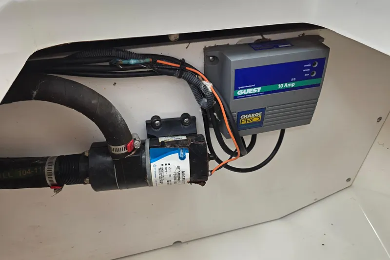 Slide: The Image of Electrical components inside a 2003 Boston Whaler 255 Conquest boat, featuring a Guest Charge Pro. - 32