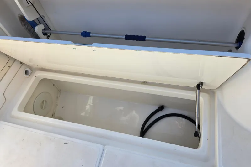 Slide: The Image of Open storage compartment on a 2003 Boston Whaler 255 Conquest boat. - 35