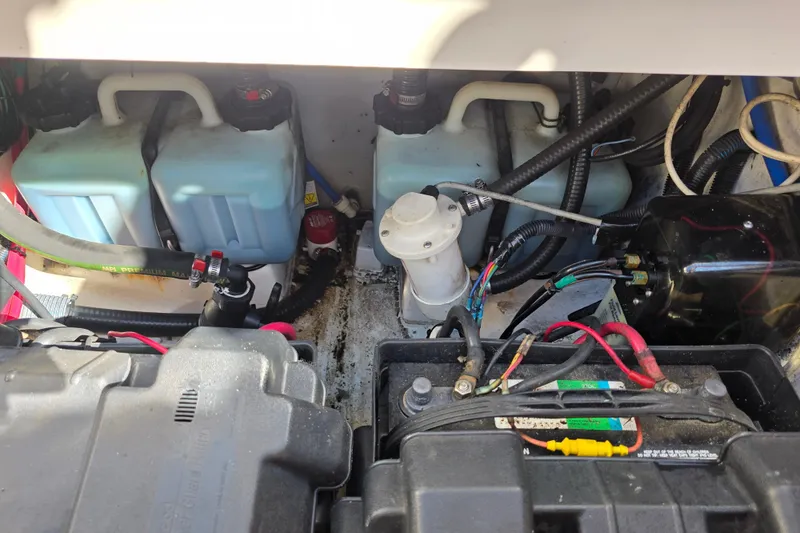 Slide: The Image of Engine compartment of a 2003 Boston Whaler 255 Conquest with visible wiring and components. - 37