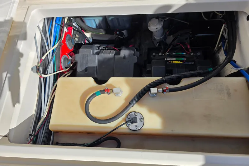 Slide: The Image of Engine compartment of a 2003 Boston Whaler 255 Conquest boat, showing wiring and components. - 38