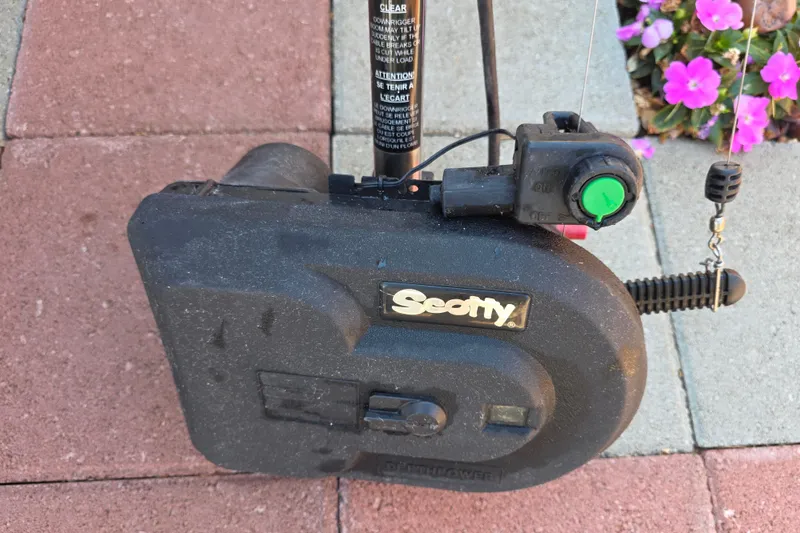 Slide: The Image of Scotty downrigger on Boston Whaler 255 Conquest, 2003 model, with flowers in background. - 41