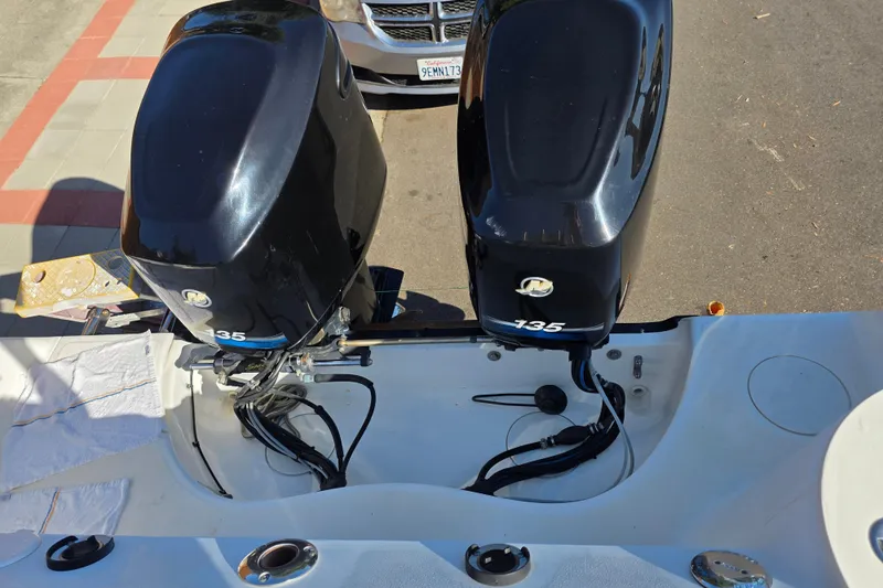 Slide: The Image of Twin 135 HP outboard engines on a 2003 Boston Whaler 255 Conquest boat. - 8
