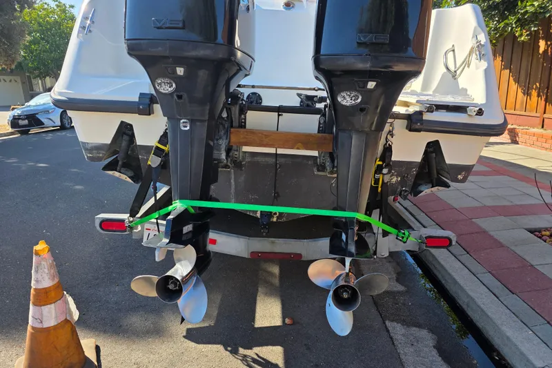 Slide: The Image of 2003 Boston Whaler 255 Conquest boat with dual outboard motors on a trailer. - 9