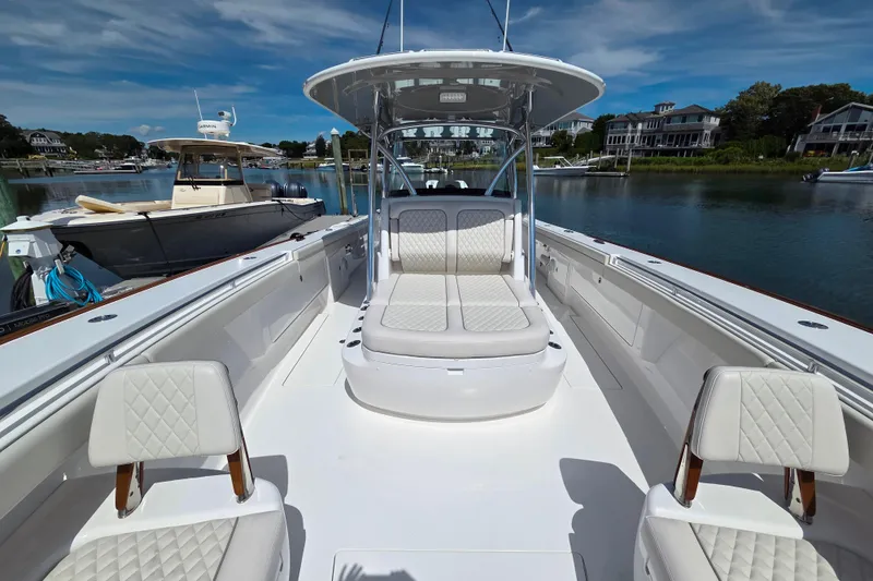 Slide: The Image of 2025 Valhalla Boatworks V-41 with luxurious seating, docked in a serene marina setting. - 3