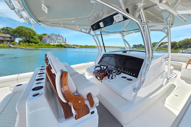 Slide: The Image of 2025 Valhalla Boatworks V-41 cockpit with luxurious seating and advanced controls, docked by a scenic waterfront. - 9