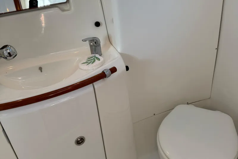 Slide: The Image of Bathroom interior of 2002 Beneteau Oceanis 393 yacht, featuring sink and toilet. - 10