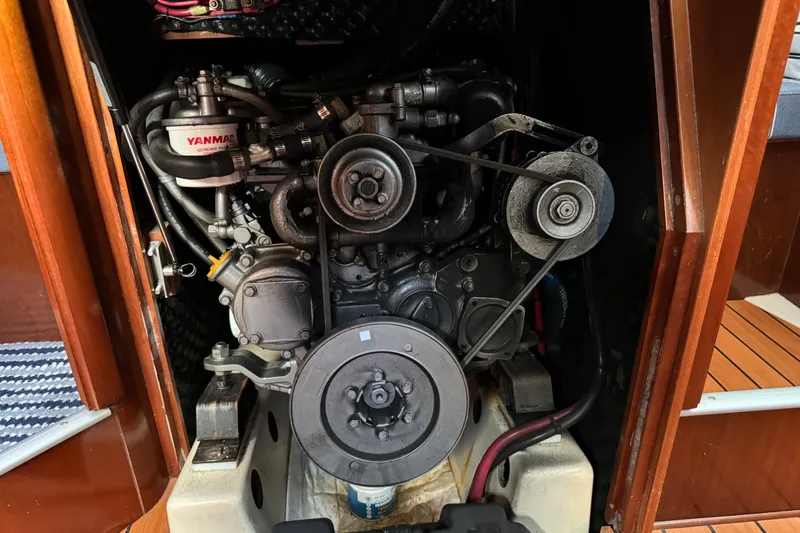 Slide: The Image of Engine compartment of a 2002 Beneteau Oceanis 393 sailboat, featuring a Yanmar engine. - 11