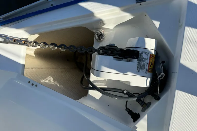 Slide: The Image of Anchor chain and windlass on a 2002 Beneteau Oceanis 393 sailboat deck. - 22