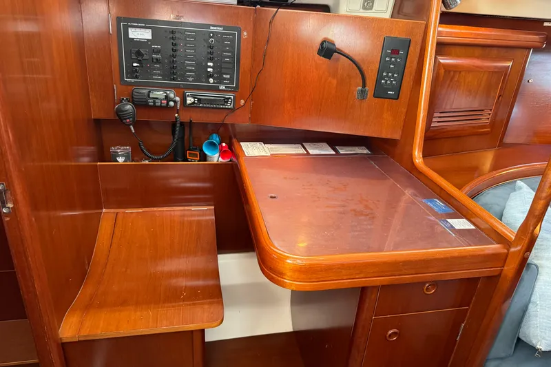 Slide: The Image of Navigation station on 2002 Beneteau Oceanis 393 sailboat with control panel and radio equipment. - 5
