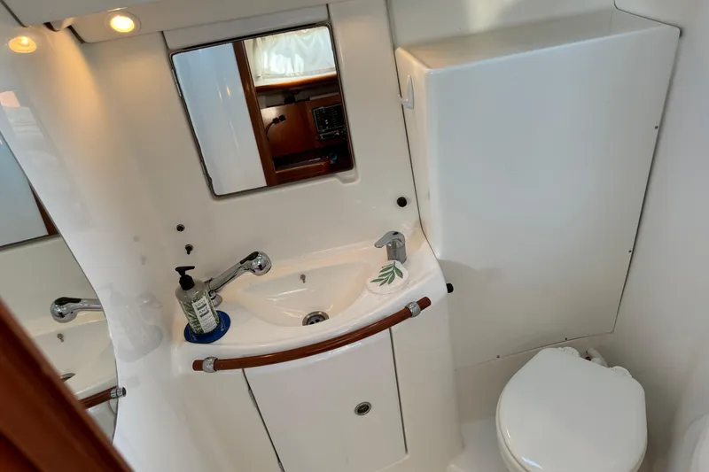 Slide: The Image of Bathroom interior of 2002 Beneteau Oceanis 393 yacht, featuring sink and toilet. - 9