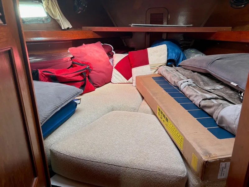Slide: The Image of Cozy cabin interior of 1984 Irwin 41 sailboat with cushions and storage items. - 17