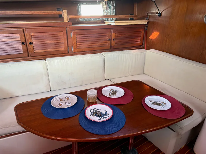 Slide: The Image of Cozy interior of 1984 Irwin 41 sailboat with nautical-themed table setting. - 19