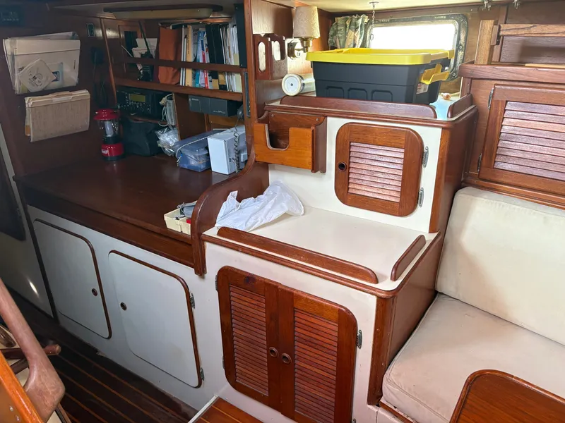 Slide: The Image of Interior of 1984 Irwin 41 sailboat with wooden cabinets and storage area. - 20