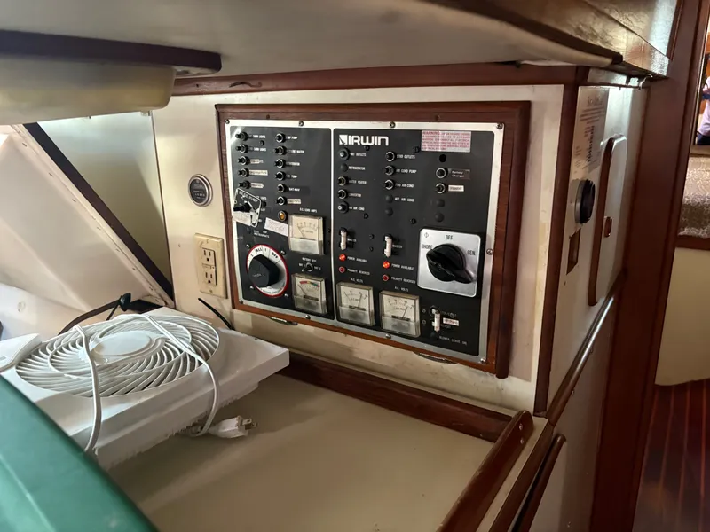 Slide: The Image of Electrical control panel on a 1984 Irwin 41 sailboat, featuring switches and meters. - 23